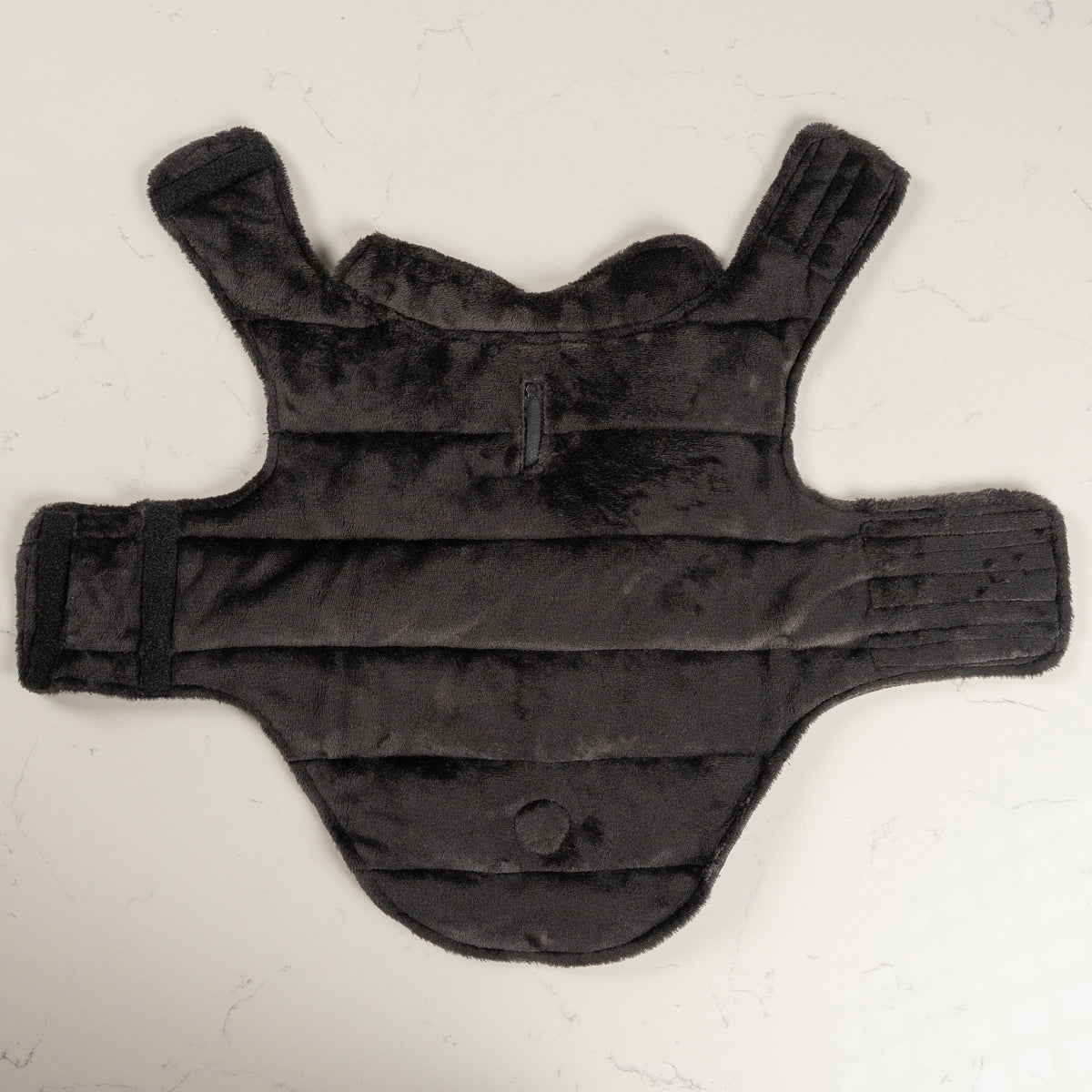 Soft black plush fleece lining of the Midnight Black dog puffer coat laid flat