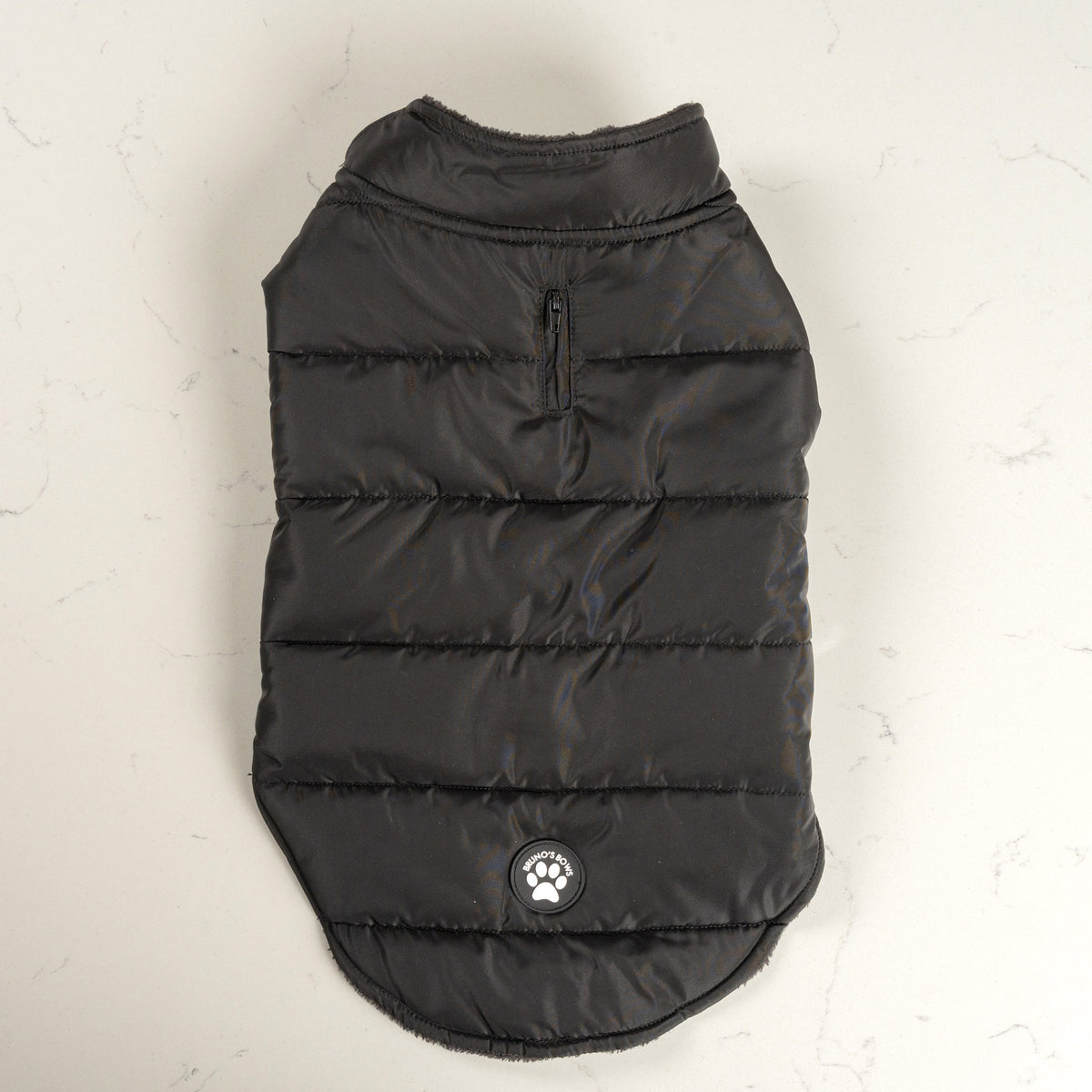 Midnight Black dog puffer coat from above with zipped lead opening and Bruno's Bows badge
