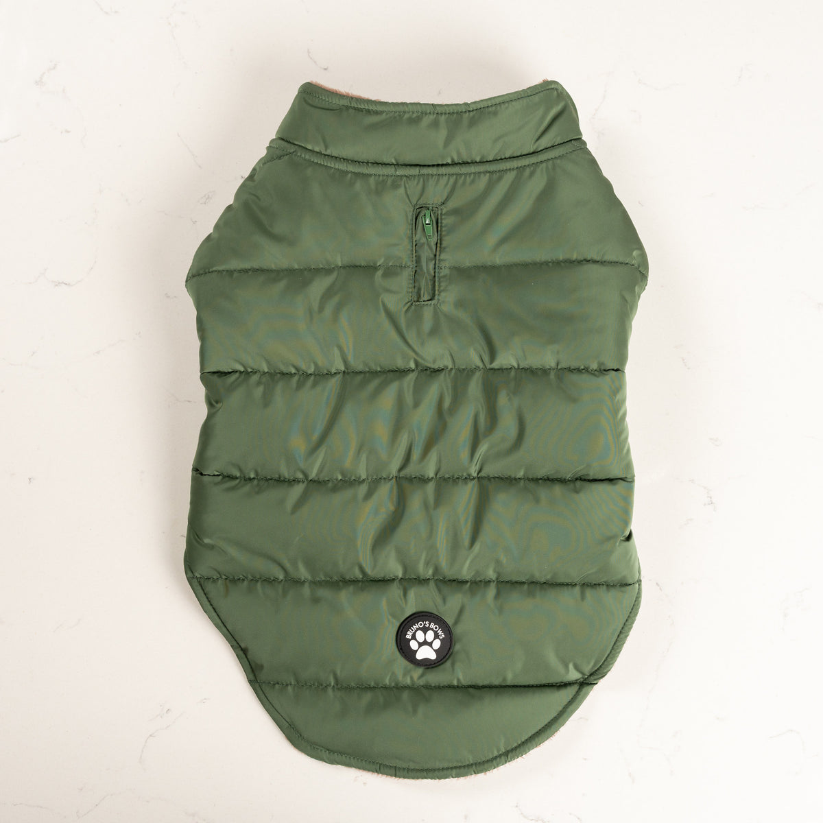 Woodland Green dog puffer coat from above with zipped lead opening and Bruno's Bows badge